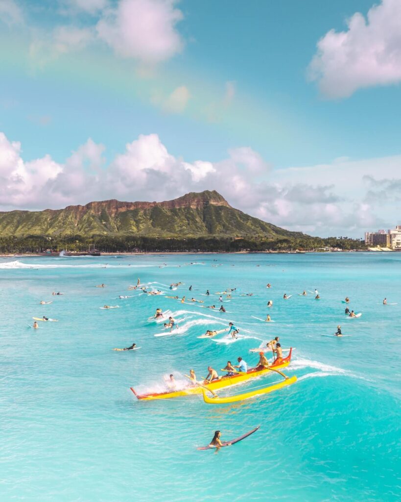 Kayakers riding a wave in Honolulu